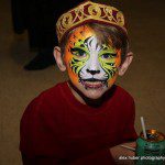 A kid with tiger face paint